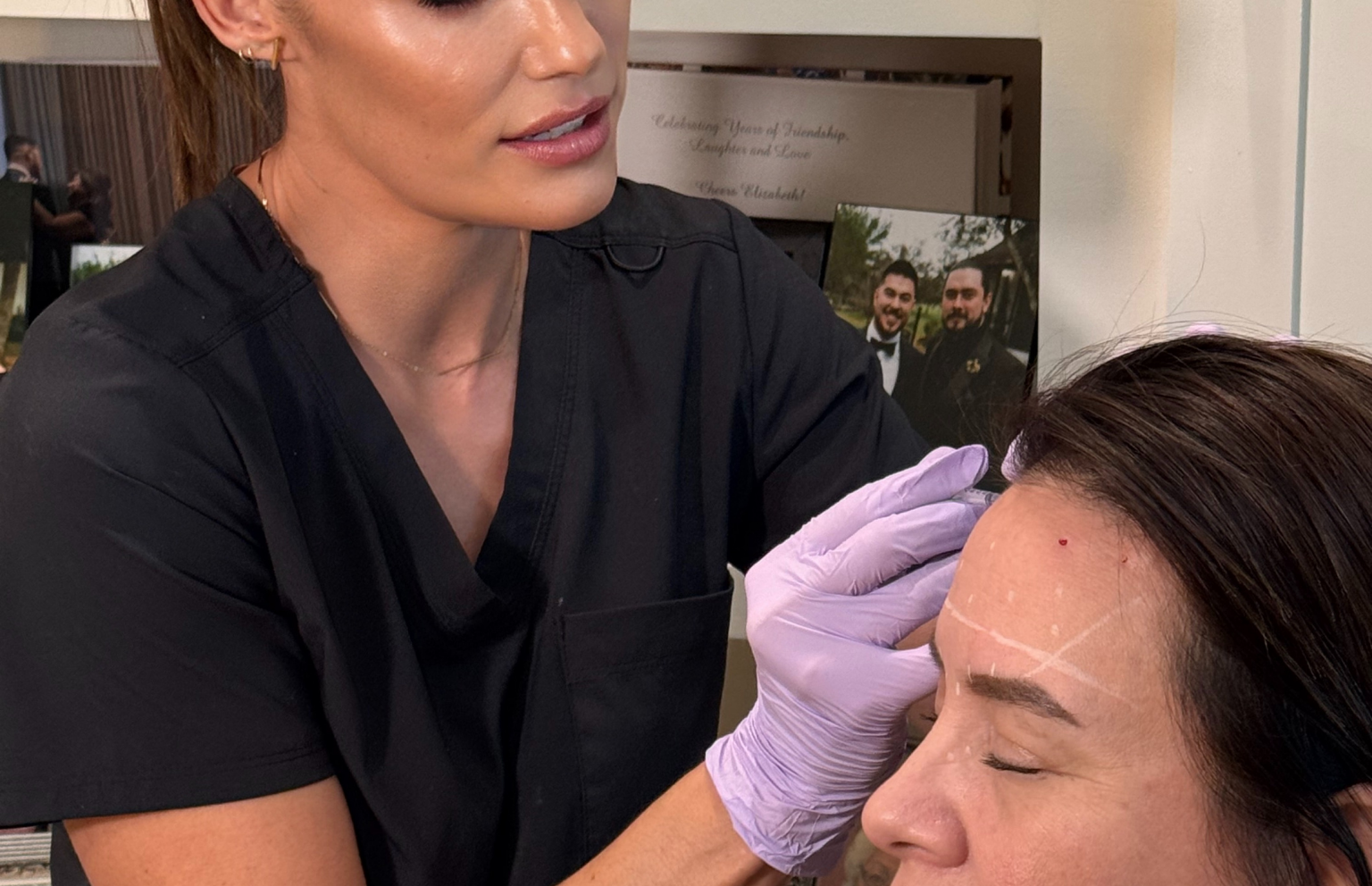 Taliah explaining facial mapping before treatment at Tula Tu Aesthetics in The Woodlands, TX